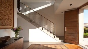 A modern interior with a staircase, wooden flooring, and a wooden door. - Loft with terrace overlooking Porto-Vecchio salt marshes (Porto-Vecchio)