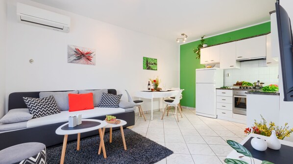A modern apartment with a living area, dining space, and kitchen.