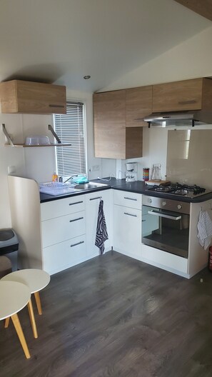 Fridge, microwave, coffee/tea maker, cookware/dishes/utensils