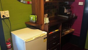 A compact kitchen with a refrigerator, microwave, and coffee maker. - Stylish Studio on South terrace. 2 Minute walk to the beach. (South Fremantle)
