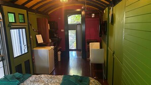 A room with a bed, a desk, a chair, and a window. - Stylish Studio on South terrace. 2 Minute walk to the beach. (South Fremantle)