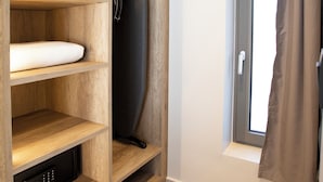 A room with a wooden shelving unit containing a mattress, a black appliance, and a small electronic device. - Villa Virgo Ammoussa Lefkada (Lefkada)