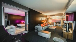 A modern hotel room with a living area, a separate bedroom, and a dining area. - One Bedroom | 1.5 Baths & Living Room | Jet Tub – Palms Place StripSuite- NO RESORT FEE (Las Vegas)