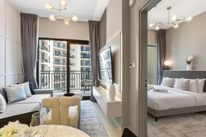 Een moderne hotelkamer met een bank, een eettafel en een televisie.