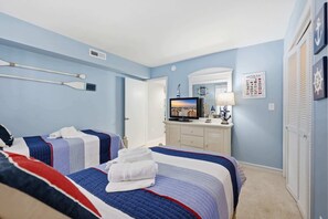 A hotel room with two beds, a television, a dresser, and nautical-themed decor. - Anchorage by the Sea Ocean View Balconies and Pool (Myrtle Beach)