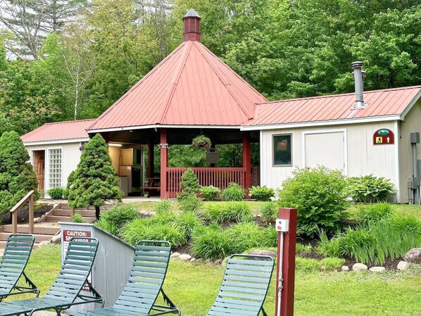 A small building with a red roof, a porch, and a sign indicating a spa.