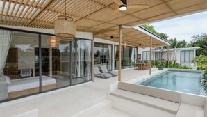 A modern outdoor living area with a pool, glass walls, and a wooden ceiling. - Tropical Poolside Retreat by Sea N' Rent (Ko Pha-ngan)