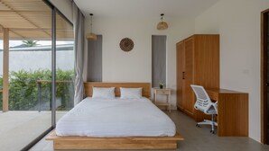 A modern bedroom with a large bed, a desk, and a chair. - Tropical Poolside Retreat by Sea N' Rent (Ko Pha-ngan)