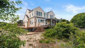 A two-story house with a large deck and a covered outdoor area. - Private Beach, Water Views, Incredible Location! (Chatham)