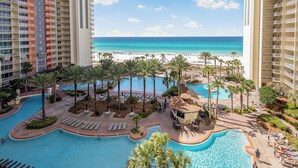 A resort with a pool, beach, and ocean view.