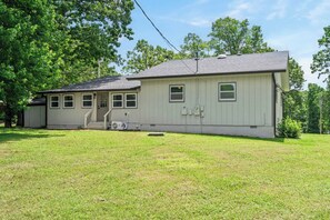 A single-story house with a front porch, a garage, and a small front yard.