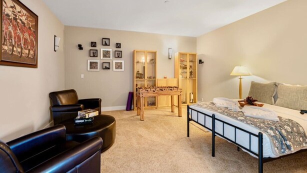 A bedroom with a bed, a desk, a chair, and a wardrobe. - 2BR Hideaway: Bar Vibes, Game & LEGO Joy @Bellevue (Bellevue)