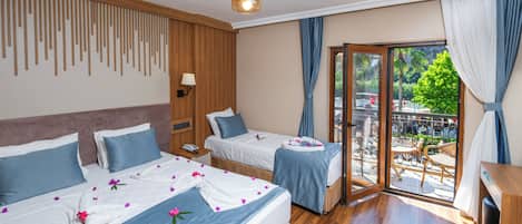 A hotel room with two beds, a balcony with a view, and a wooden ceiling.