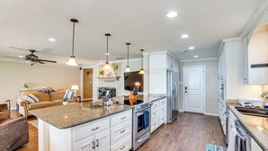 A spacious kitchen with a central island, white cabinetry, and a built-in oven. - Waterfront Retreat w/ Dock on Cedar Creek Lake! (Kemp)