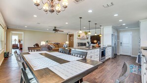 A spacious kitchen with a central island, pendant lighting, and a ceiling fan. - Waterfront Retreat w/ Dock on Cedar Creek Lake! (Kemp)