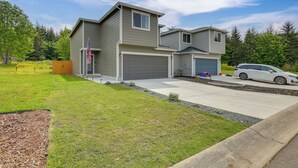 A two-story house with a garage, a driveway, and a lawn. - 2 Mi to Olympic National Park: Sun-soaked Haven! (Port Angeles)