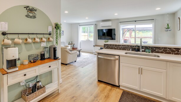 A modern kitchen with a coffee station, a dishwasher, and a large window. - 2 Mi to Olympic National Park: Sun-soaked Haven! (Port Angeles)