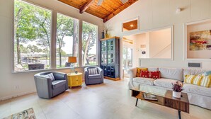 A spacious living room with large windows, a wooden ceiling, and a cozy seating area. - Live Lake Life! Enchanted Oaks Gem w/ Private Dock (Mabank)