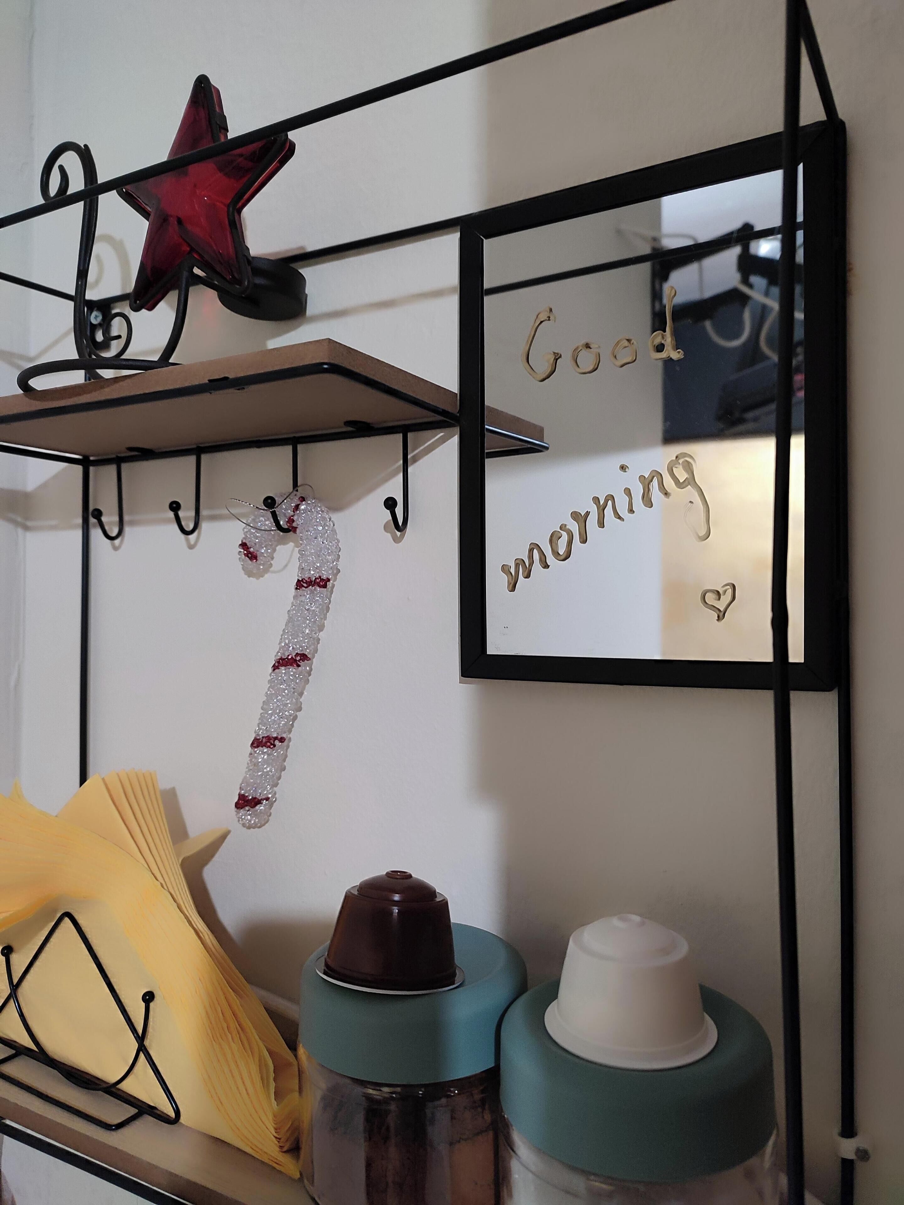 A wall-mounted mirror with the words "Good morning" and a heart symbol.
