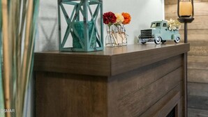 A wooden console table with a teal lantern, small vases with flowers, and a toy truck. - Slopeside Serenity 111–Cabin Vibe–Sleeps 4 (Gatlinburg)