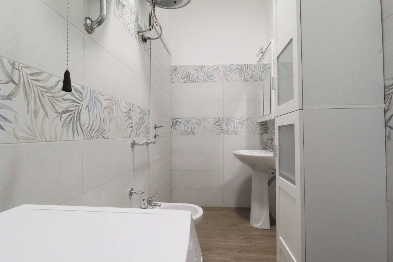 A bathroom with a bathtub, a sink, and a shower.