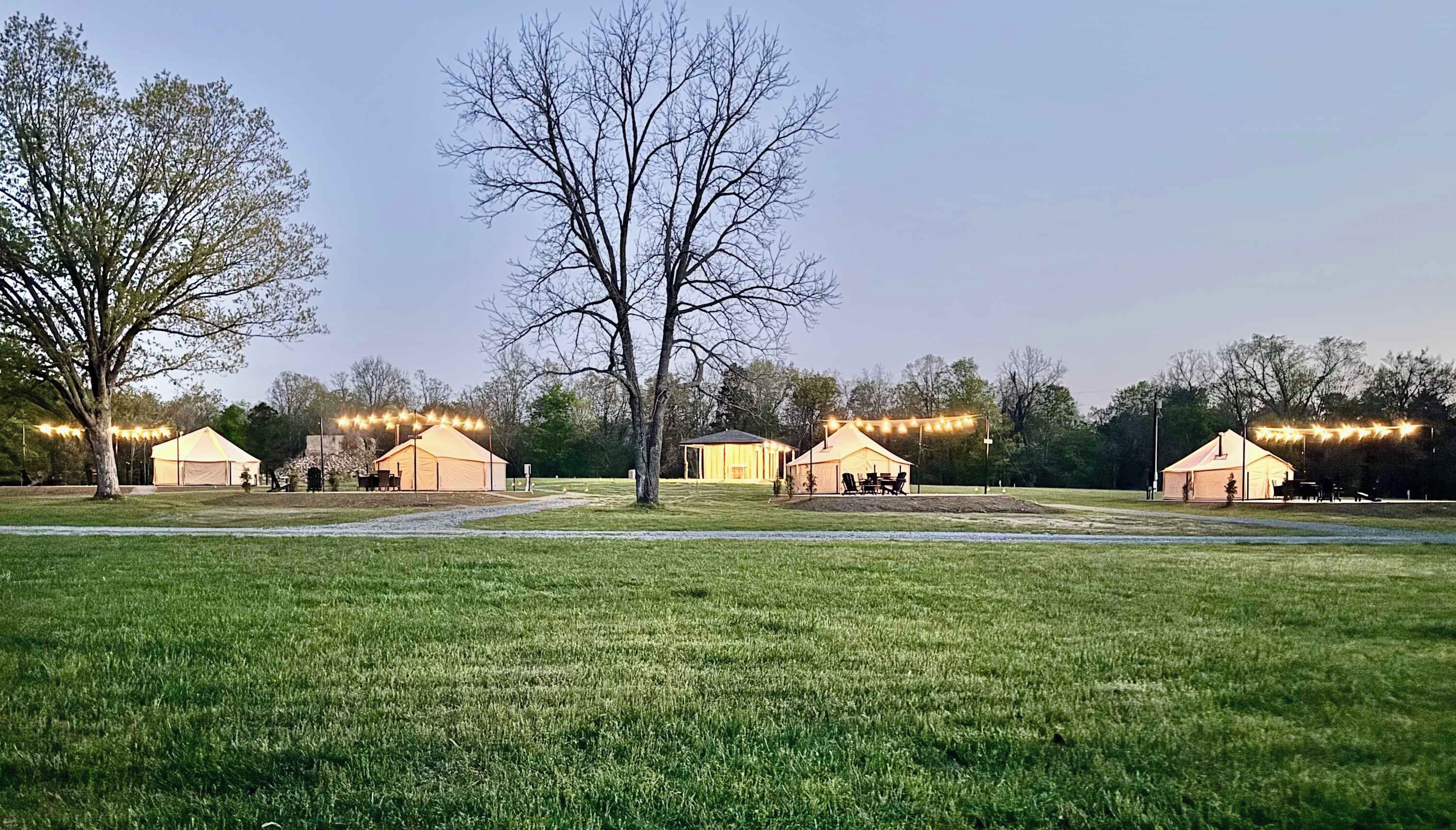 A campsite with tents and a grassy field.