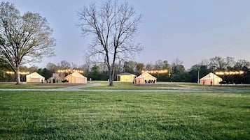 A campsite with tents and a grassy field.