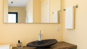 A bathroom with a modern sink, a mirror, and green cabinets. - Villa Flavia - Luxury Retreat (Polignano a Mare)