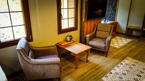 Deluxe Suite, City View | Living area | TV