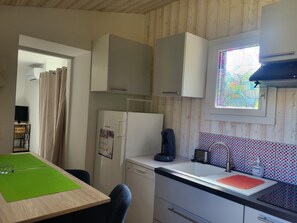 A compact kitchen with a refrigerator, a coffee maker, a toaster, and a window with a stained glass view. - Le Meillonais Country House, fully equipped. Near Bazas and the Sauternes region (Le Nizan)