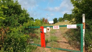 A gated area with signs indicating a property number and a contact number. - BlackSea-side base for your European adventure. (Primorsko)