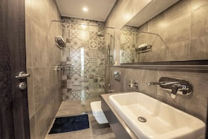 A modern bathroom with a walk-in shower, a large bathtub, and a mirror above the sink. - 2 Bedroom at Skynest Residency Westlands (Nairobi)