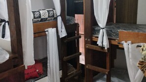 A dormitory room with bunk beds, wooden furniture, and white curtains. - house with WiFi in Guarulhos you can share room and kitchen and hall with tv (Jardim Cristina Guarulhos)