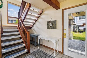 A staircase with wooden railings leading to a landing with a white console table and a wall-mounted picture. - 3 BR/2BA home in So. Bethany (South Bethany)