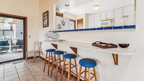 A kitchen with white cabinets, a blue countertop, and four blue bar stools. - 3 BR/2BA home in So. Bethany (South Bethany)
