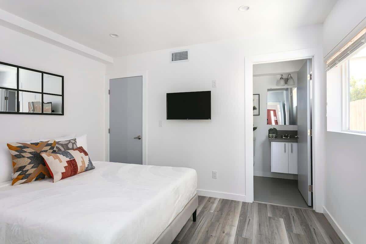 Relaxing bedroom space with modern decor and TV.