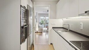 A modern kitchen with stainless steel appliances, a built-in oven, and a large sink. - Ulia Terrace by FeelFree Rentals (San Sebastian)