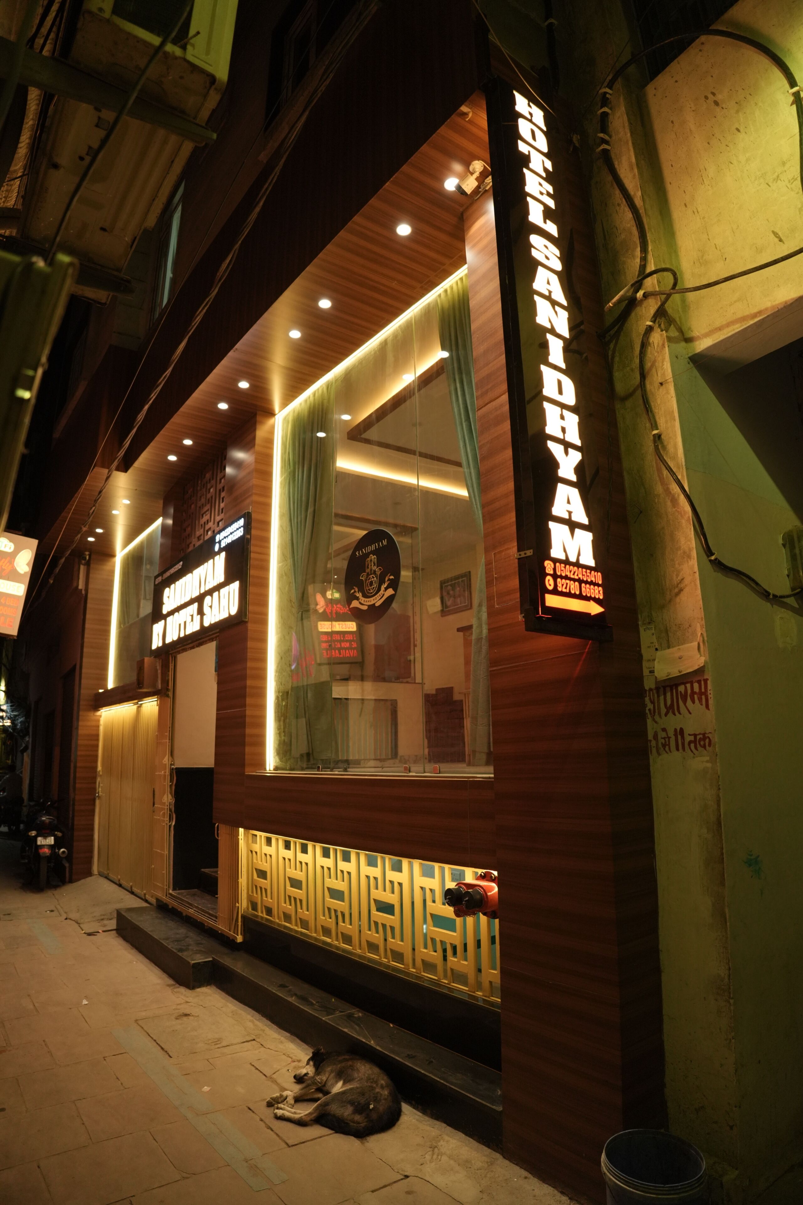 A hotel with a prominent sign, a wooden facade, and a visible entrance.