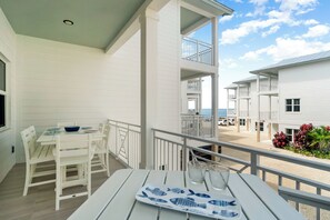 A white building with a balcony overlooking the sea. - NEW - Oceanfront FL Keys Home w/Pool, Free Dockage, Gameroom, Private Balcony (Islamorada)