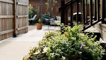 A garden area with potted plants and a wooden fence.