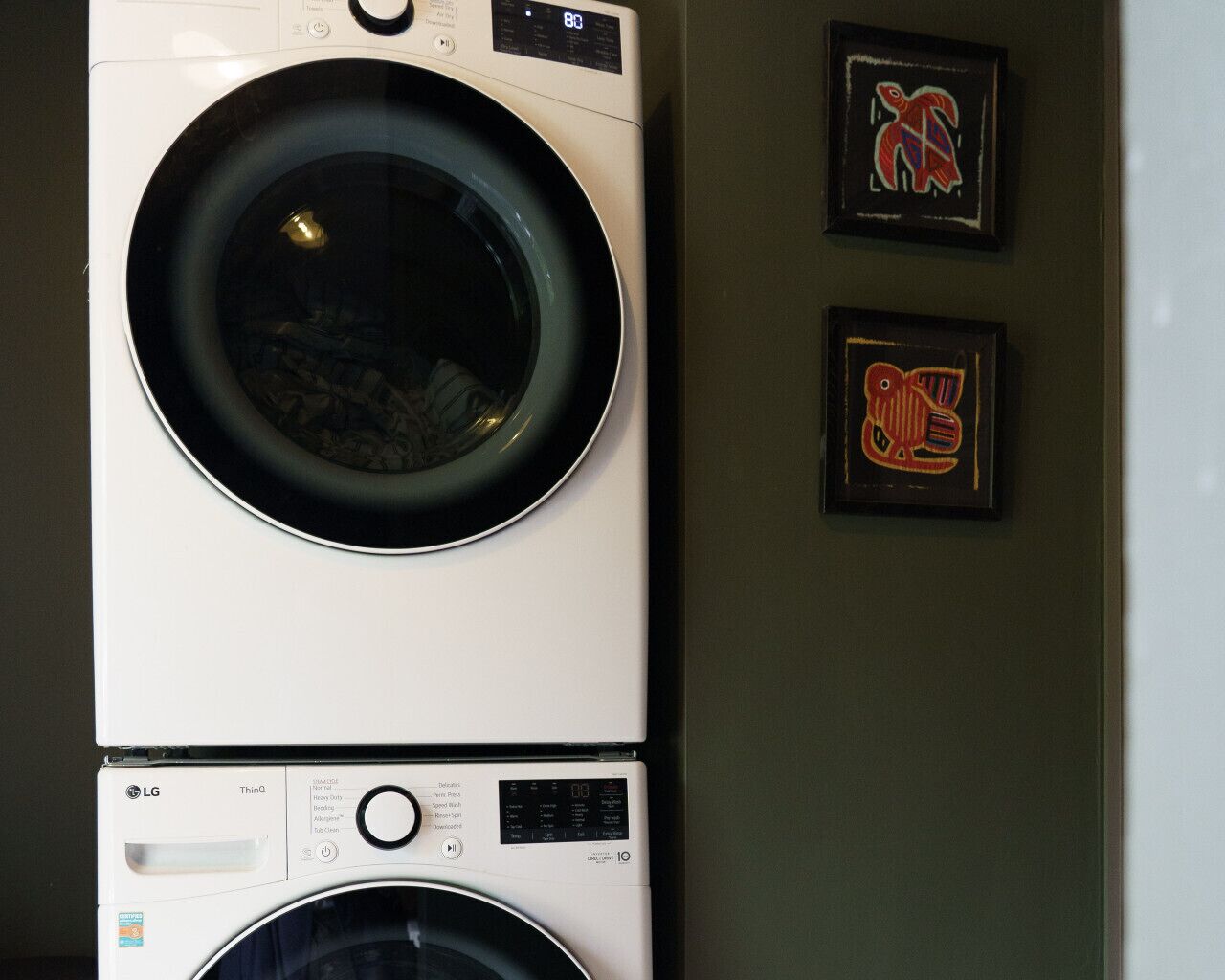 A stacked washer and dryer unit with a control panel and a digital display.