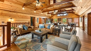 A spacious log cabin interior with a living area, kitchen, and dining space. - 16 Bedrooms, 2 Heated Pools, 1 Epic Getaway (Sevierville)