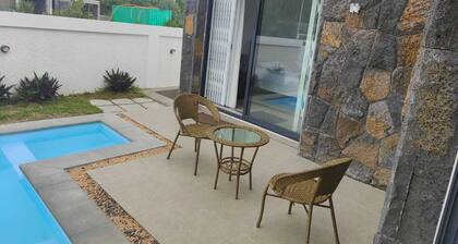 Luxury villa near Bras d'Eau Beach with private pool and lush natural views.
