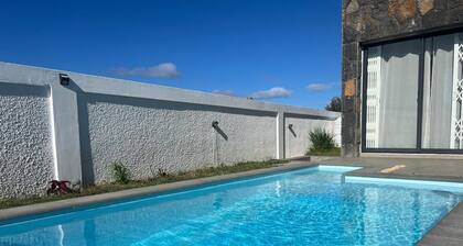 Luxury villa near Bras d'Eau Beach with private pool and lush natural views.