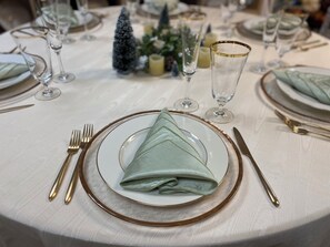 A table set for a formal dining occasion with a folded napkin, cutlery, and glassware.