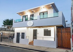 A modern two-story building with a sign reading 'CASA TAPIA.' - Modern San Juan Apt w/ Parking Near Ocean Park (San Juan)