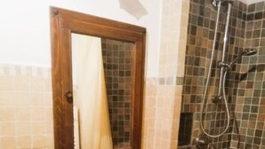 A bathroom with a white sink, a mirror, a shower, and tiled walls. - "Lovely Home" Cozy Bike Friendly Holiday Home with Wi Fi (Buonconvento)