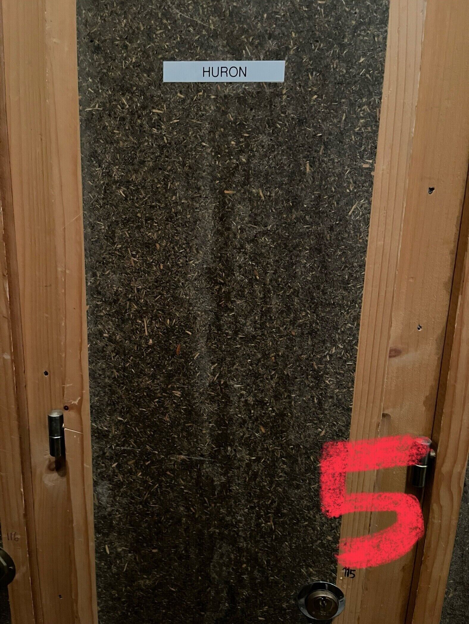 A door with a label 'HURON' and a number '5' painted on it.