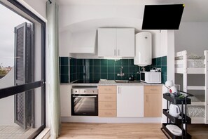 Fridge, microwave, coffee/tea maker, cookware/dishes/utensils