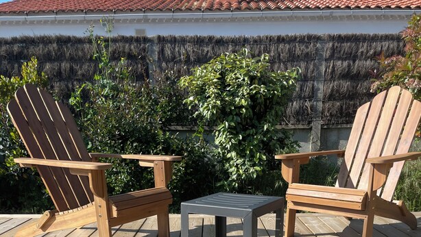 A wooden deck with two Adirondack chairs and a small table. - Vacation home, Villa Hortense (Notre-Dame-de-Monts)